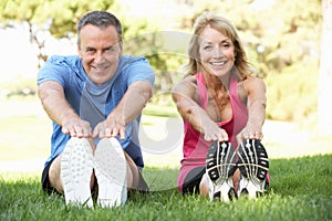 Senior Couple Exercising In Park