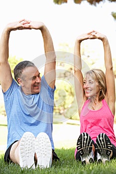 Senior Couple Exercising In Park