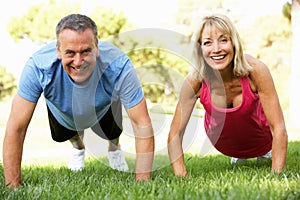 Senior Couple Exercising In Park