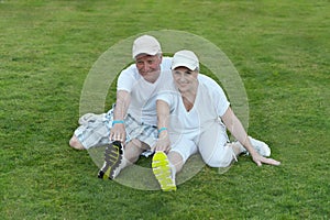 Senior couple exercising in park