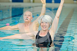 senior couple exercising in swimming pool