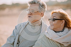 senior couple in eyeglasses hugging