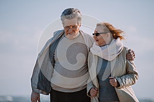 senior couple in eyeglasses hugging