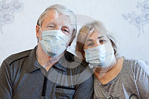 Senior couple facial portrait, two mature people wearing face masks at home