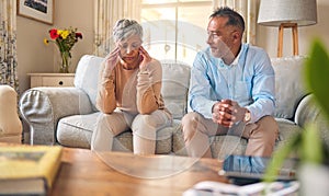 Senior couple, fight and divorce in stress, conflict or argument from disagreement on living room sofa at home. Elderly