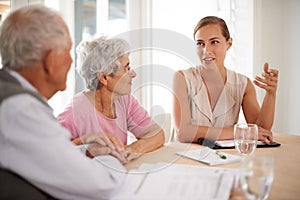 Senior, couple or financial advisor with discussion for insurance, retirement planning or contract documents by table