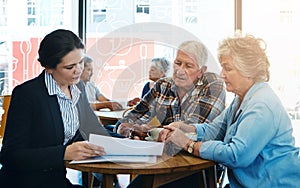 Senior couple, financial advisor and meeting with documents in consultation, conversation and retirement plan. Insurance