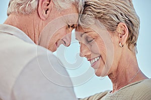 Senior, couple with forehead touch and smile for love with care, bonding and retirement outdoor. Elderly man, woman and