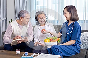 Senior couple get medical advice visit from caregiver nutritionist at home while having suggestion on fresh vegetable meal for