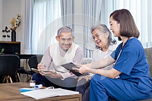 Senior couple get medical service visit from caregiver nurse at home while having result of medical exam for health care and