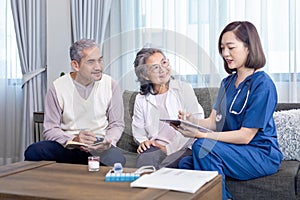 Senior couple get medical service visit from caregiver nurse at home while having result of medical exam for health care and