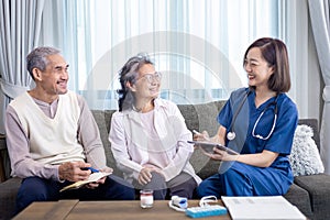 Senior couple get medical service visit from caregiver nurse at home while having result of medical exam for health care and