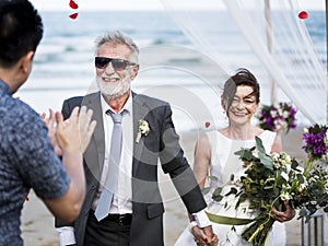 Senior couple getting married at the beach