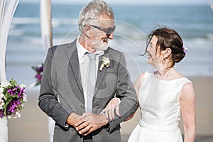 Senior couple getting married at the beach