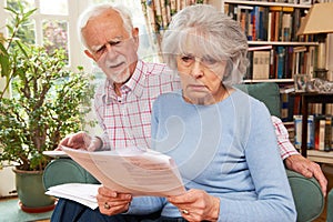 Senior Couple Going Through Finances Looking Worried