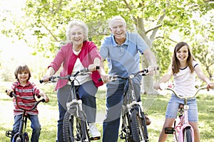 Senior couple with grandchildren on bikes