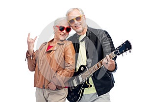 Senior couple with guitar showing rock hand sign