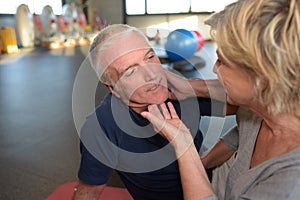 senior couple in gym working out together