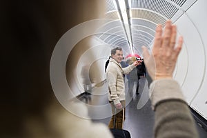 Senior couple in hallway of subway saying goodbye