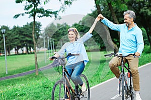 senior couple happy elderly love together retirement bicycle bike man woman mature fun