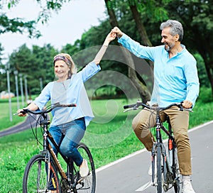 senior couple happy elderly love together retirement bicycle bike man woman mature fun