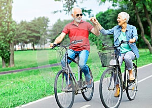 senior couple happy elderly love together retirement bicycle bike man woman mature fun