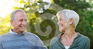 Senior couple, happy and love outdoor at a park with a smile, care and support for health and wellness. A elderly man
