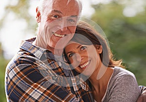 Senior couple, happy and portrait for hug, love or outdoor in nature with connection for retirement. Woman, elderly man