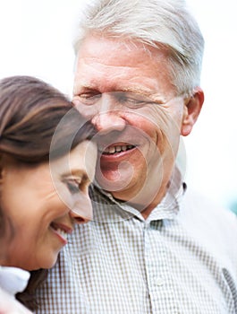 Senior couple, happy and smiling with hug and marriage with embrace, outdoor and retired. Retirement, elderly or love