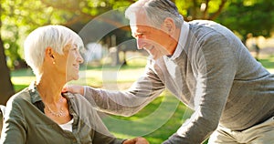 Senior couple, happy and talking outdoor at a park with love, care and support. A elderly man and woman in nature for