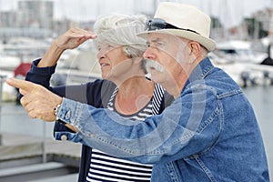 senior couple harbourside looking at view