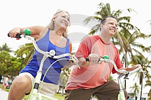 Senior Couple Having Fun On Bicycle Ride