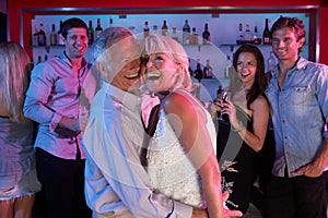 Senior Couple Having Fun In Busy Bar