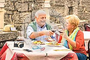 Senior couple having fun and eating at restaurant during travel