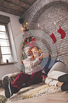 Senior couple having fun at home on Christmas day