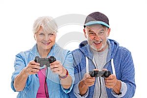Senior couple having fun playing video games