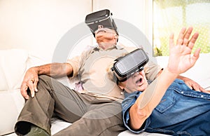 Senior couple having fun together with virtual reality headset