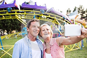 Senior couple having a good time at the fun fair