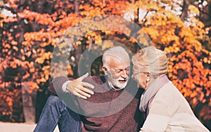 Senior couple having picnic in autumn park