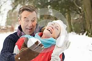 Senior Couple Having Snowball Fight