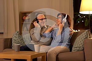 Senior couple with headphones listening to music