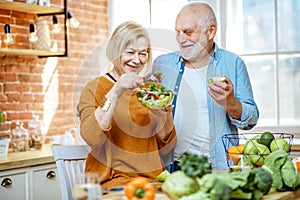 Senior couple with healthy food at home