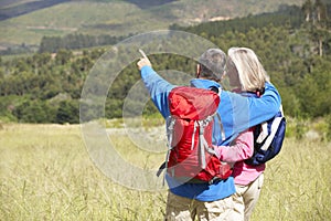 Senior Couple On Hike Through Beautiful Countryside