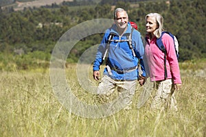 Senior Couple On Hike Through Beautiful Countryside