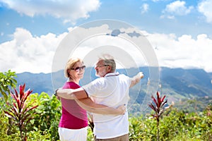 Senior couple hiking in mountains and jungle