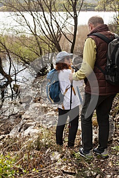 senior couple hiking outdoor, man and woman norwegian walking with sticks