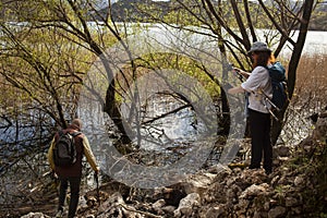 senior couple hiking outdoor, man and woman norwegian walking with sticks