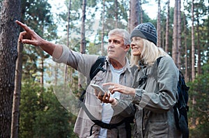Senior couple, hiking and phone outdoor in nature for direction for exercise, fitness and trekking. Old man and woman
