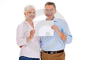 Senior couple holding blank poster