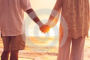 Senior Couple Holding Hands Enjoying at Sunset